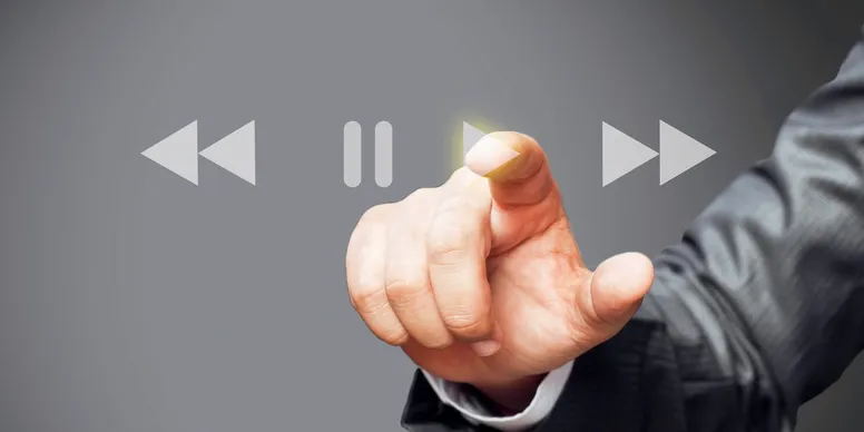 A hand reaching forward to press a button
